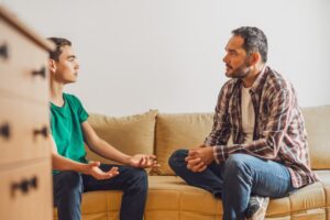 Father talking to young adult son